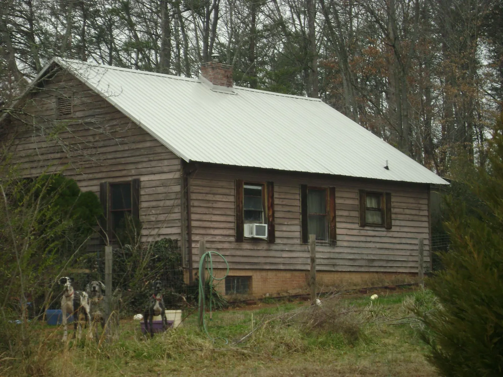 White metal roof on an old wood sided farmhouse, from a Metal Roof Installation job in Branchville
